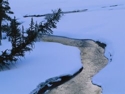 Raymond Gehman A Twilight View of Baronette Creek Winding Through a Snowy Landscape