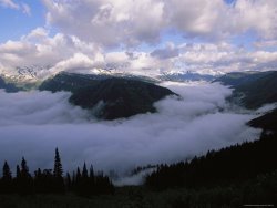 Raymond Gehman Clouds Shroud The Valley And Fill The Sky Along Logan Pass